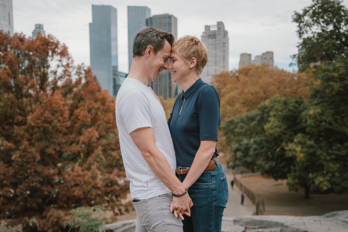 Couple touching foreheads among the fall foliage of Central Park
